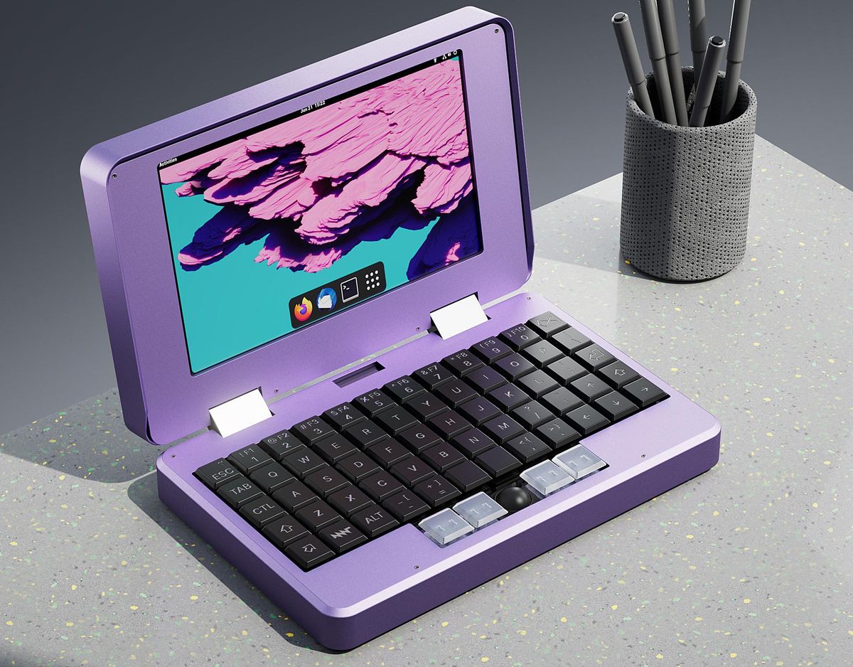桌上有一台紫色的笔记本电脑